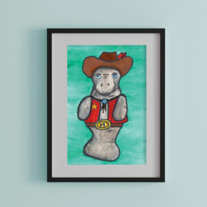 Saltwater Cowboy watercolor art print featuring a manatee dressed as a cowboy, displayed in a black frame